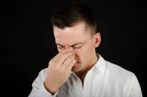 man suffering from a sinus infection