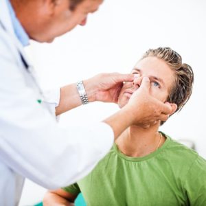 doctor examining broken nose