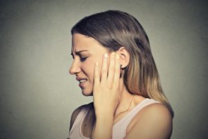 woman suffering from ear pain