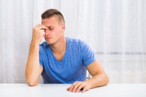 man suffering from sinus pain