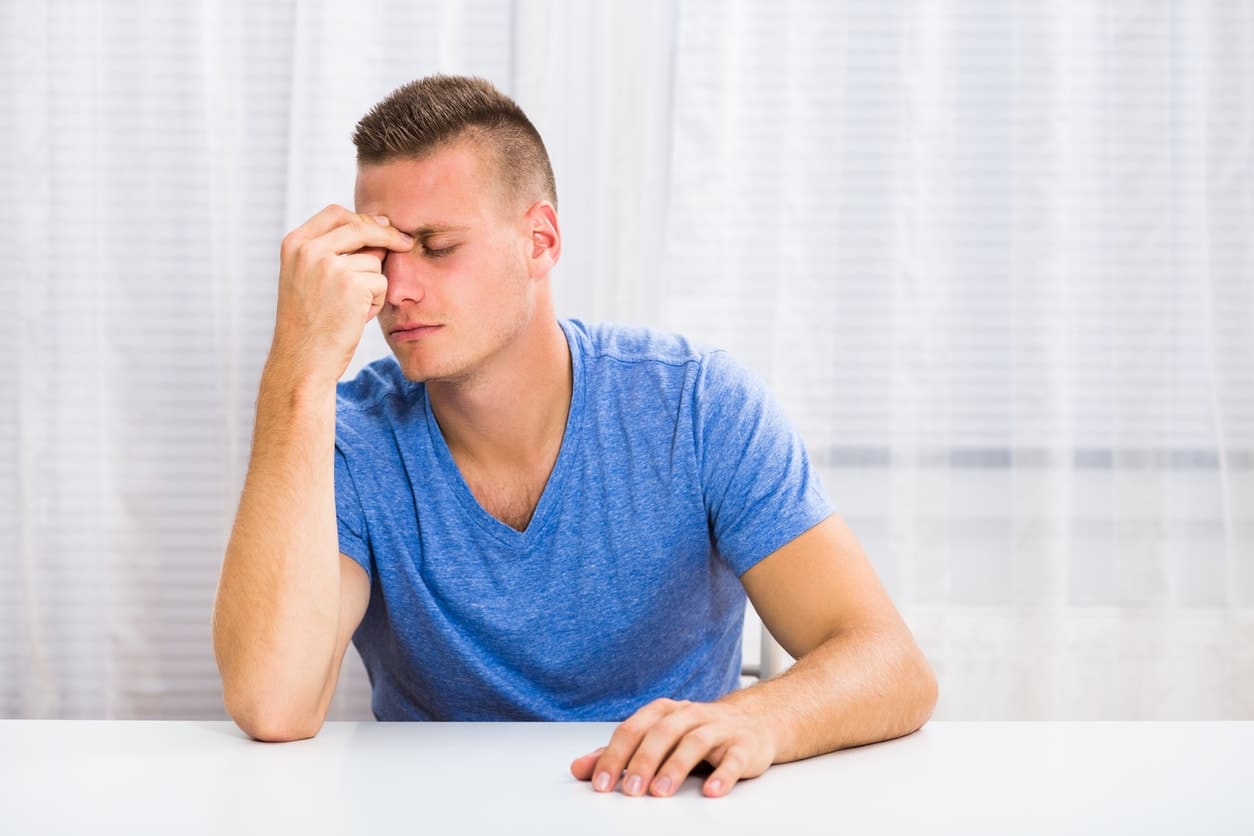 man suffering from sinus pain