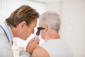 man getting ears checked out