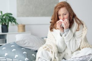 woman with a sinus infection in bed