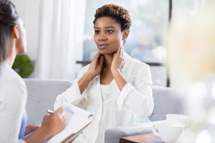 Female patient describes symptoms to doctor