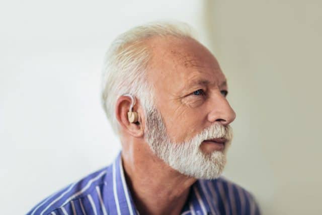 man with hearing aid e1557775602492