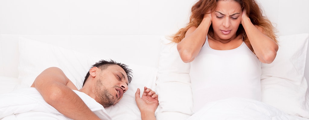 man snoring next frustrated significant other