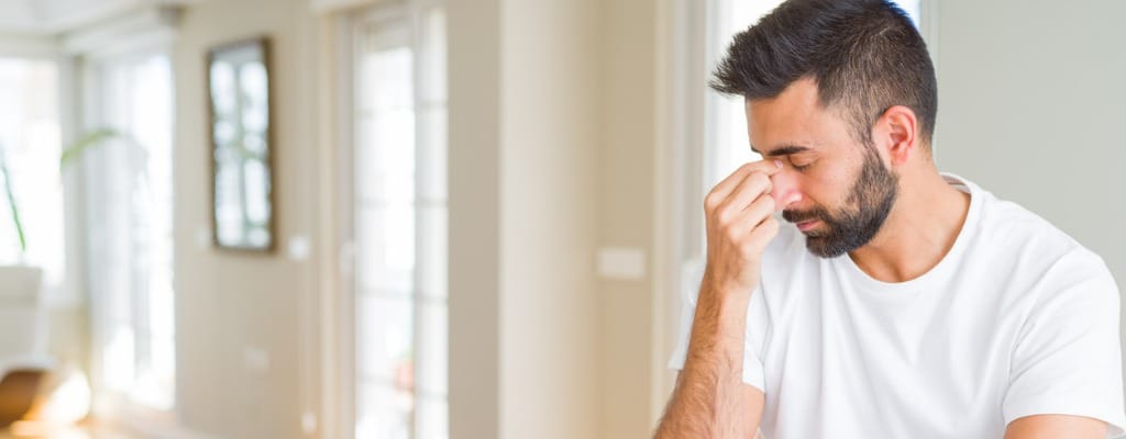 handsome hispanic man casual white tshirt at home tired rubbing nose picture id1205750791