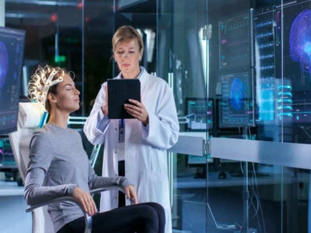 In the Modern Brain Study Laboratory Monitors Show EEG Reading and Brain Model