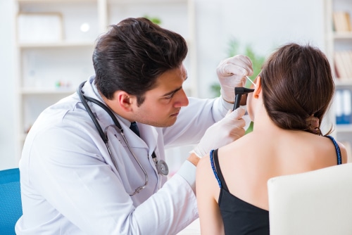 Doctor checking patients ear during medical examination